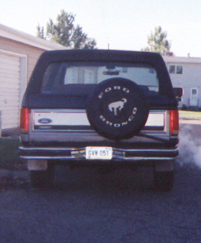 1986 Ford Bronco - Rear view of a Ford Bronco, likely from the late 1980s, showing its spare tire and license plate.