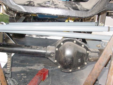 1979 Ford Bronco - Underside view of a vehicle's rear differential and suspension components, with gray bars visible above.