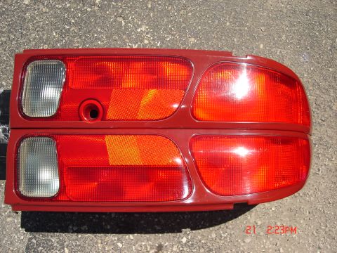 1993 Ford Probe - A pair of red taillights are shown, likely for a car, against a textured background.
