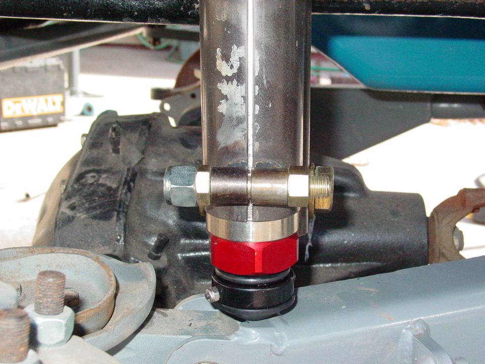 Close-up of a red and black shock absorber mount with metal tubing and bolts