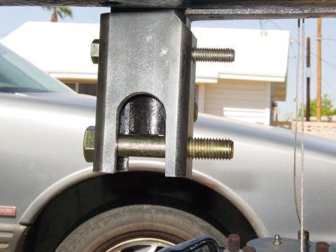 1979 Ford Bronco - A close-up view of a suspension component attached to the side of a silver 1979 Ford Bronco.