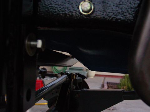 1979 Ford Bronco - Undercarriage view of vehicle suspension components, with a water hose in the background.