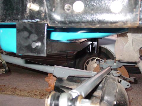 1979 Ford Bronco - Close-up view of a vehicle's front suspension system, showing various mechanical parts and linkages.