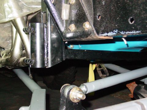 1979 Ford Bronco - Detail shot of vehicle suspension and exhaust system components, likely during maintenance or modification.