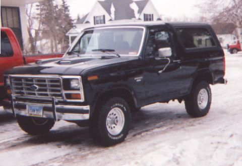 1986 Ford Bronco - Black 1986 Ford Bronco with a new paint job parked outside in the snow.
