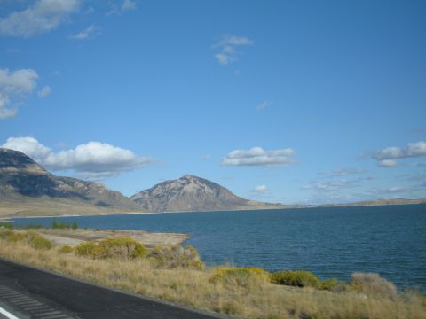 1998 BMW R1100GS ABS - A scenic view of a lake and mountains on a clear day, with a road visible in the foreground.