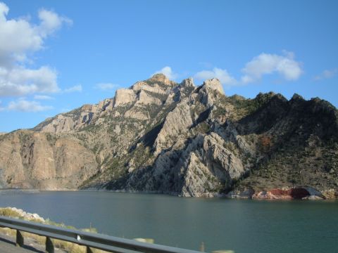 1998 BMW R1100GS ABS - Scenic view of a mountain range and lake, with a guardrail visible in the foreground.