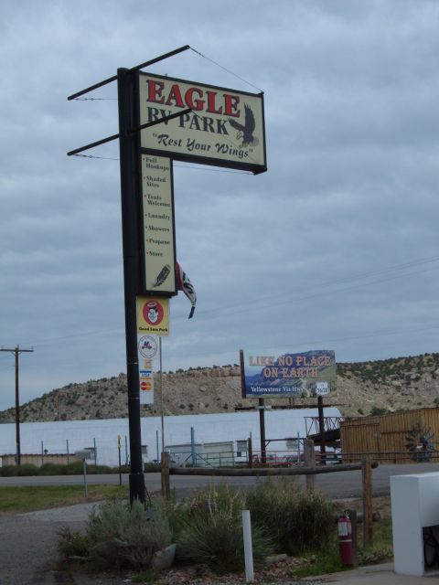 1998 BMW R1100GS ABS - Signage for Eagle RV Park, its name, tagline, and a list of services offered.