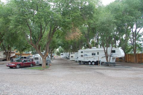1998 BMW R1100GS ABS - A red sedan and Airstream trailer are parked at a campsite with several RVs.