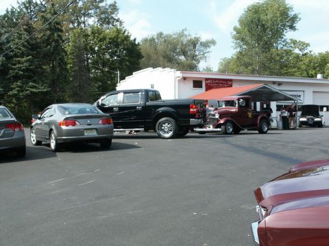 2001 Mercury Grand Marquis - A variety of vehicles are parked in a lot, including a modern pickup truck and an older model car.