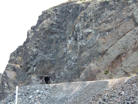 1998 BMW R1100GS ABS - A mine entrance is visible in a steep, rocky mountainside, with a pile of rubble below.