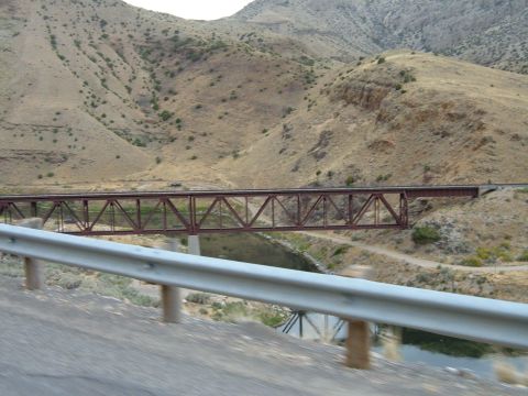 1998 BMW R1100GS ABS - A view of a desert landscape a railway bridge spanning a river, with dry, rolling hills in the background.