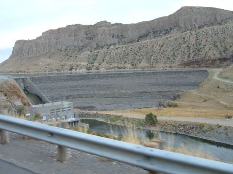 1998 BMW R1100GS ABS - View of a large dam and reservoir with a rocky mountain range behind it.