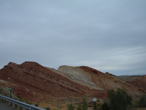 1998 BMW R1100GS ABS - Layered rock formations dominate the landscape under an overcast sky, with a guardrail visible in the foreground.