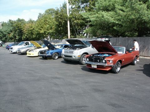 2001 Mercury Grand Marquis - Several vehicles are parked in a line with their hoods open at an outdoor car show.