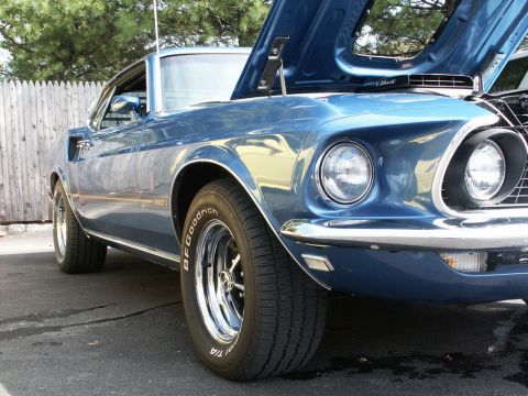 2001 Mercury Grand Marquis - A blue 1969 Ford Mustang Mach 1 is displayed with its hood up, revealing the engine bay.
