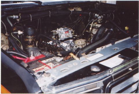 1986 Ford Bronco - Engine bay of a 1986 Ford Bronco, a prominent carburetor.