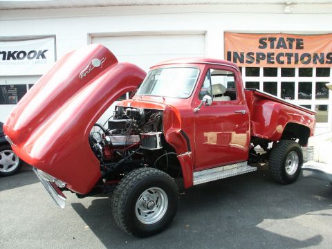 2001 Mercury Grand Marquis - This red Ford pickup truck has its hood open, revealing the engine bay and aftermarket wheels.