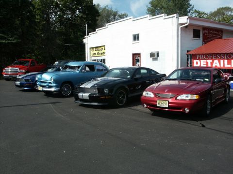 2001 Mercury Grand Marquis - A row of vehicles are parked outside a business that offers professional detailing services.