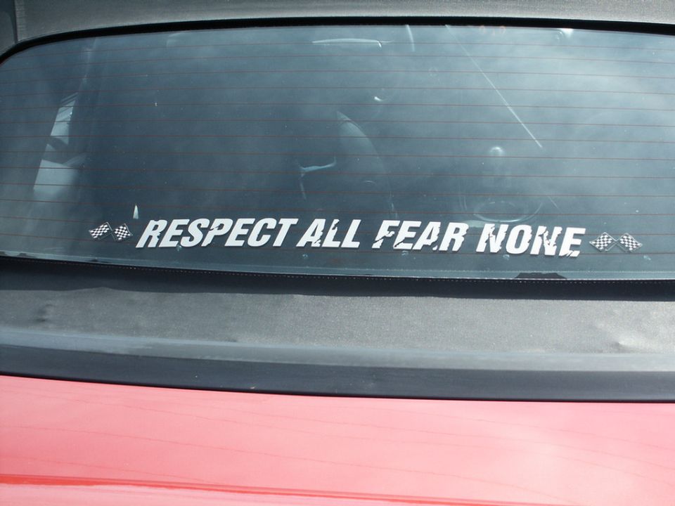 Rear window sticker reading "RESPECT ALL FEAR NONE" with checkered flags