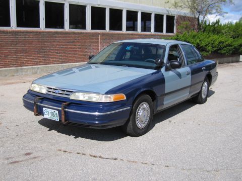 2001 Ford Crown Victoria - This 2001 Ford Crown Victoria has a two-tone blue paint job and is parked in front of a brick building.