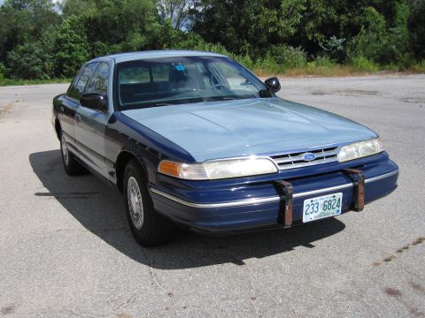 2001 Ford Crown Victoria - This Ford Crown Victoria, likely a 1998 model, is seen from a three-quarter front view on a paved surface.