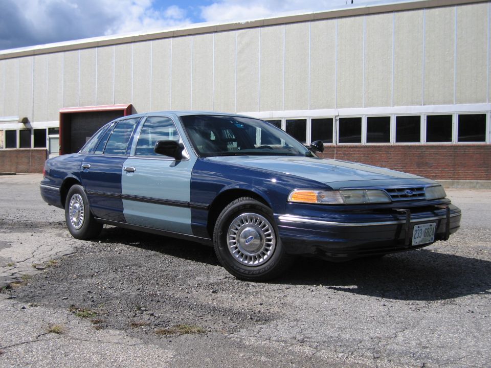 Two-tone blue Ford Crown Victoria sedan, front three-quarter view