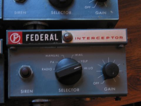 1991 Ford LTD Crown Victoria - blue Federal Interceptor siren control head rests on a wood surface, its selector marked manual, PA, radio, wail, yelp and hi-lo.