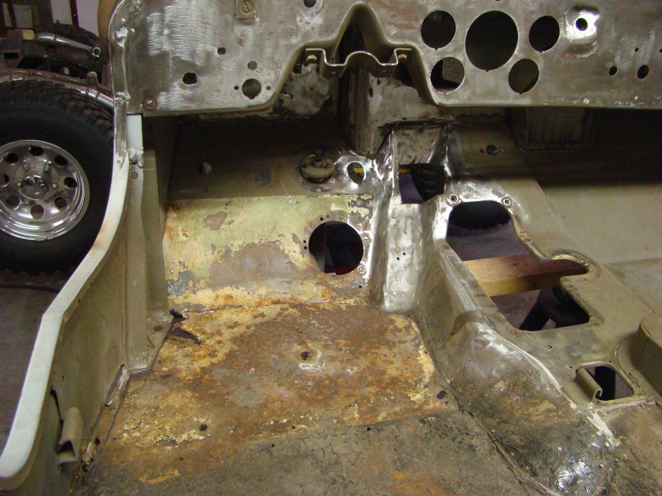 Rusty interior floor pan and firewall of a Jeep CJ-2A