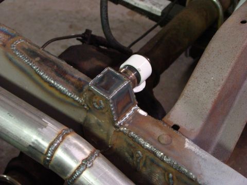 1948 Jeep Wrangler - Close-up view of custom welding on a vehicle frame, likely a Jeep CJ, with a section of exhaust pipe visible.