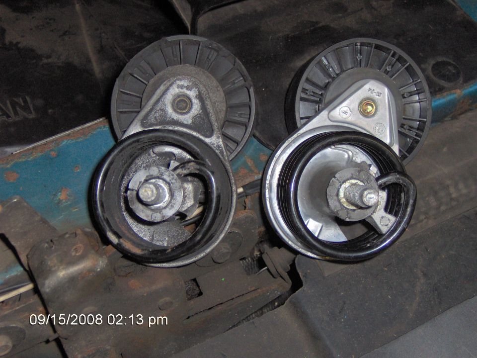 Two automotive belt tensioner pulleys, one on the left and one on the right, with visible mounting hardware and rubber belts.