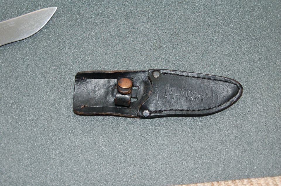 Black leather Kershaw knife sheath with embossed logo and part of a knife blade.