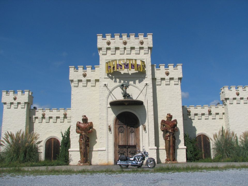 2006 Victory Kingpin motorcycle parked in front of a castle-themed building.