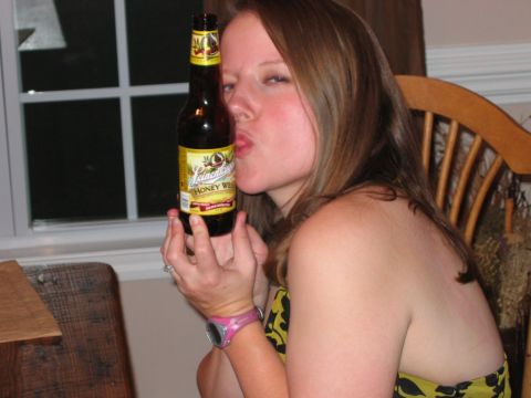 1985 Ford LTD Crown Victoria - Photo of a woman with a beer bottle at a party, not a technical document.