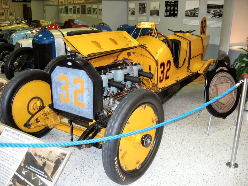Yellow number 32 vintage race car on museum display