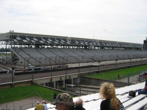 1985 Ford LTD Crown Victoria - Photograph of a racetrack grandstand and pit lane; not a technical document.