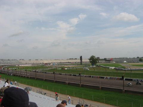 1985 Ford LTD Crown Victoria - Photograph of a racetrack and grandstands; not a technical document.
