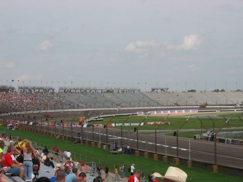 1985 Ford LTD Crown Victoria - Photograph of a packed racetrack and grandstands on race day; not a technical document.