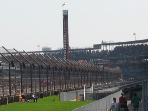 1985 Ford LTD Crown Victoria - Photograph of a racetrack scoring pylon and grandstands; not a technical document.