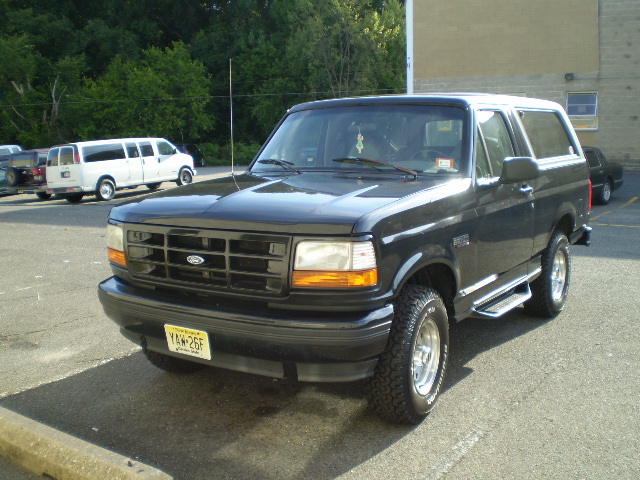 Black 1996 Ford Bronco parked in a lot, front 3/4 view.