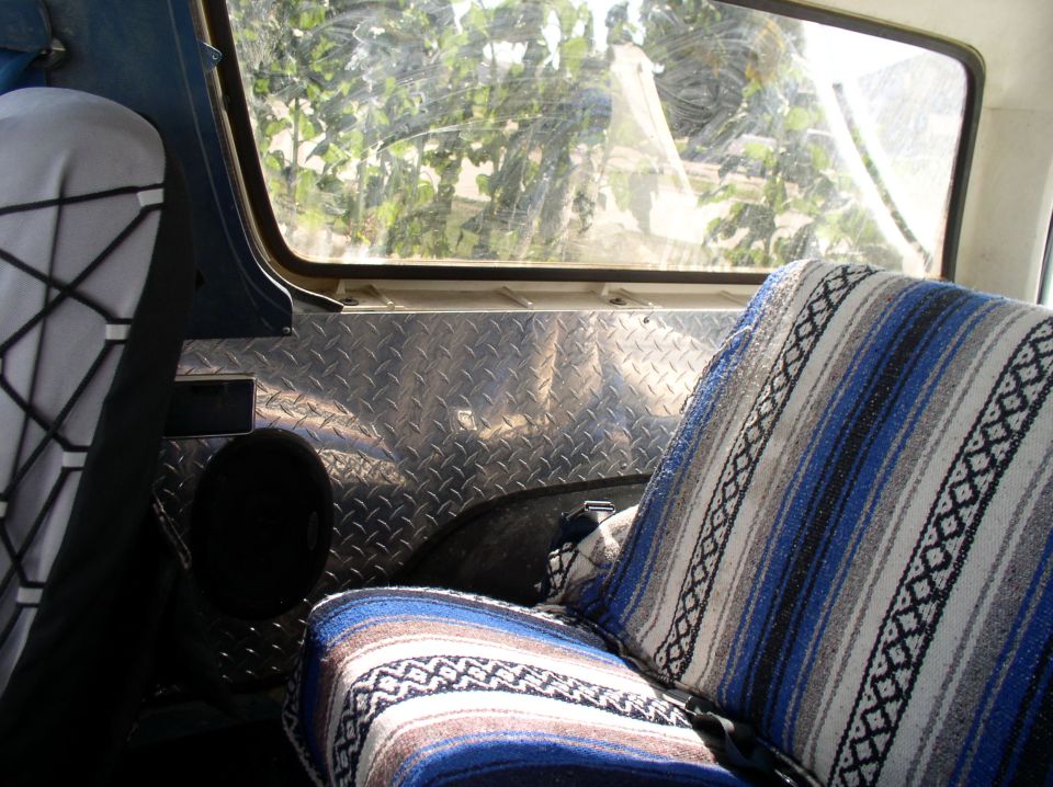 Bronco interior with blue serape blanket seat cover and diamond plate rear wall panel
