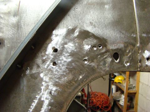 1948 Jeep Wrangler - This image shows a section of metal, likely from a vehicle body, undergoing repair or modification.