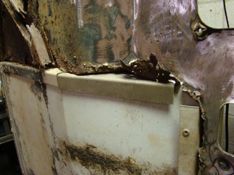 1948 Jeep Wrangler - This image shows significant rust and damage to a vehicle's body panel, indicating a need for repair.