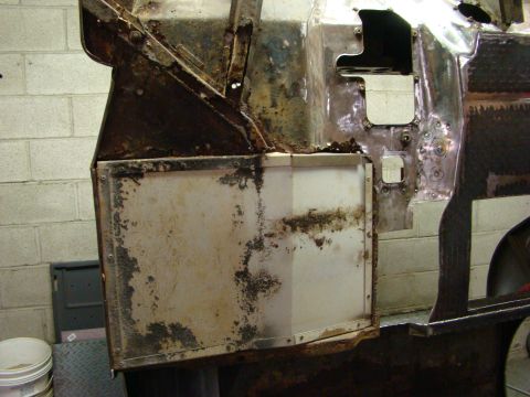 1948 Jeep Wrangler - This photo shows a heavily rusted and damaged vehicle body panel, likely undergoing restoration or repair work.