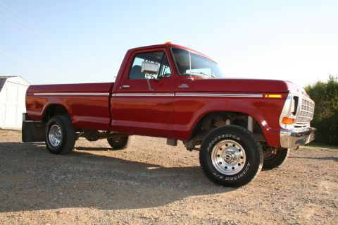 1979 Ford F-150 - This red 1979 Ford F-150 pickup truck is shown from a three-quarter front angle.