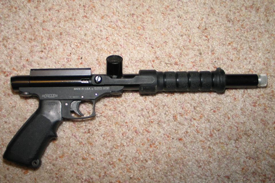 Black PMI paintball gun with textured grip and ribbed barrel