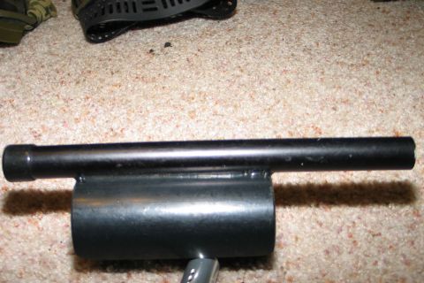 1994 Ford Bronco - A black metal component with a cylindrical base and a tube is shown close-up on a carpeted floor.