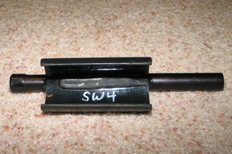 1994 Ford Bronco - A metal component marked with 'SW4' is shown against a carpeted background.