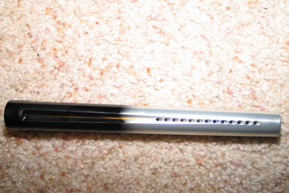 Black and silver paintball barrel with air holes