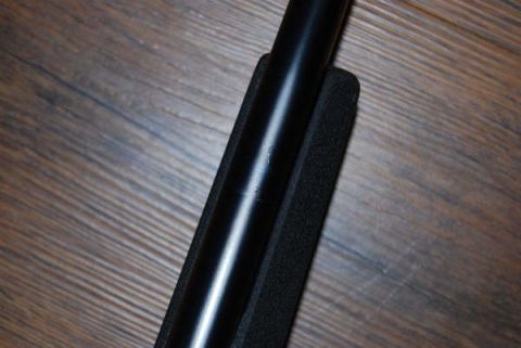 1991 Ford Bronco - A rifle barrel is shown in close-up, positioned on a foam pad against a wooden background.